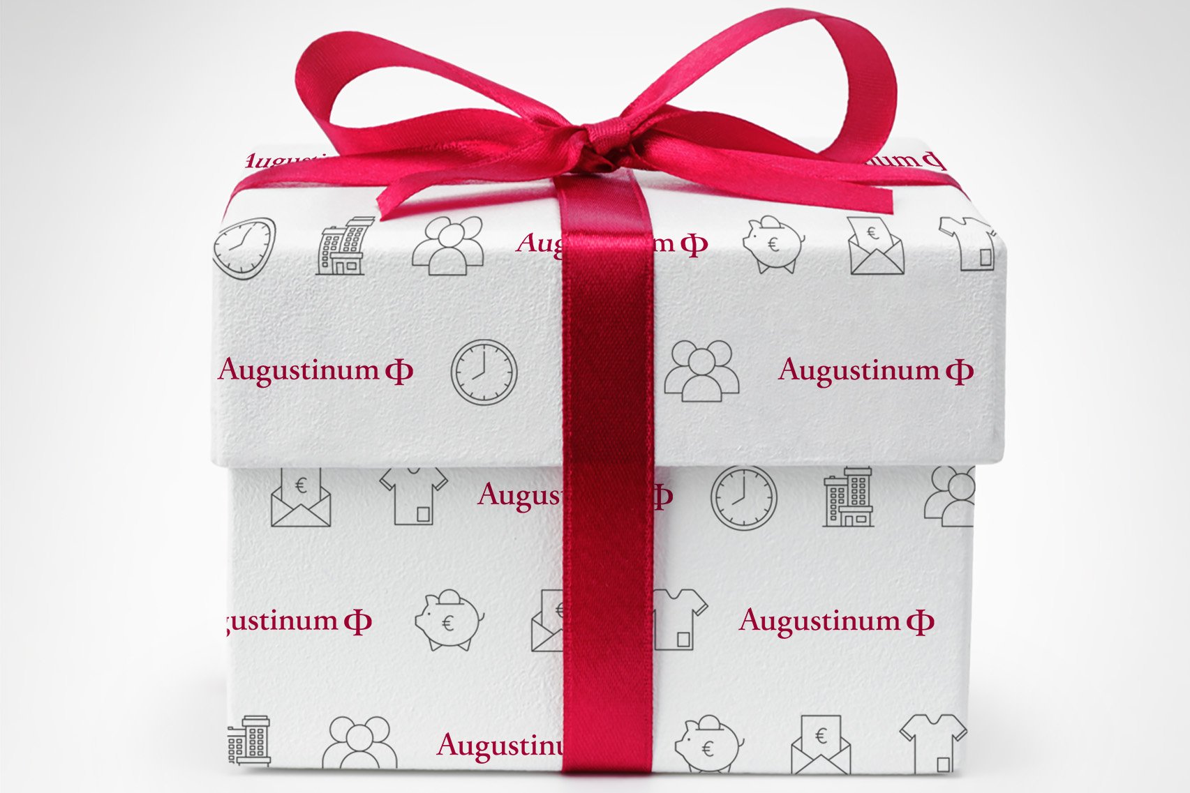 Augustinum Plus Paket Als Geschenk verpackt Schachtel mit Augustinum-Aufdruck und einer roten Schleife