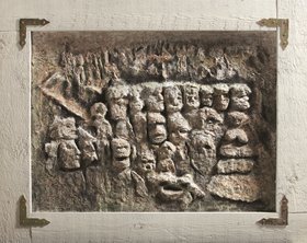 Relief mit menschlichen Köpfen von Helga Kreuzritter